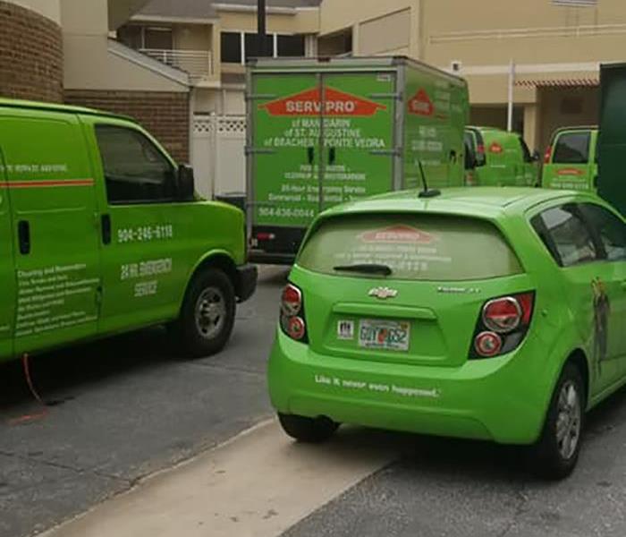 Image shows green SERVPRO cars parked in front of an assisted living facility.