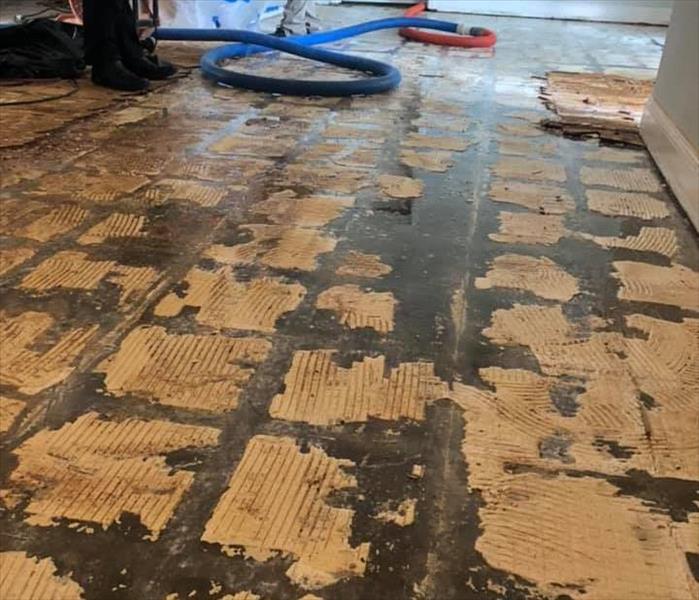 Image shows water damaged tile floor has been removed.