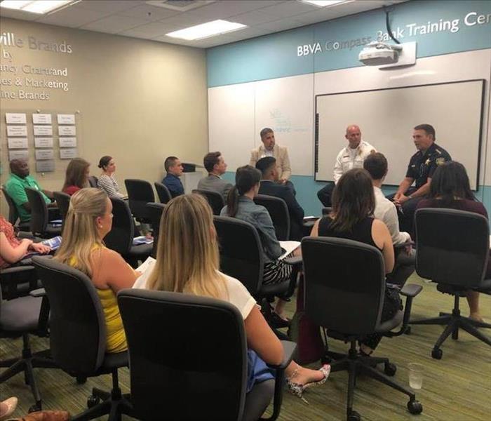 Image shows Sheriff and Fire Chief leading a classroom style discussion. 