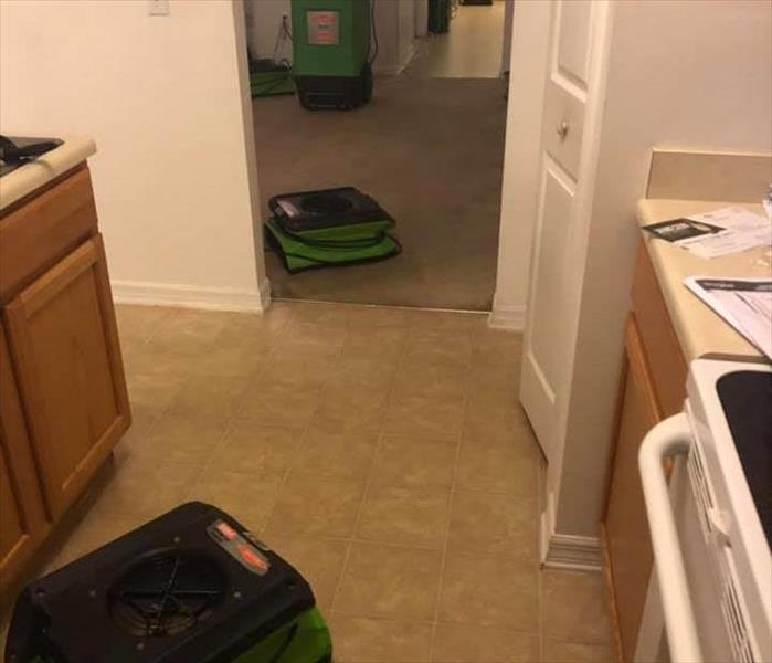 Images shows SERVPRO drying equipment on tile and carpeted floor.